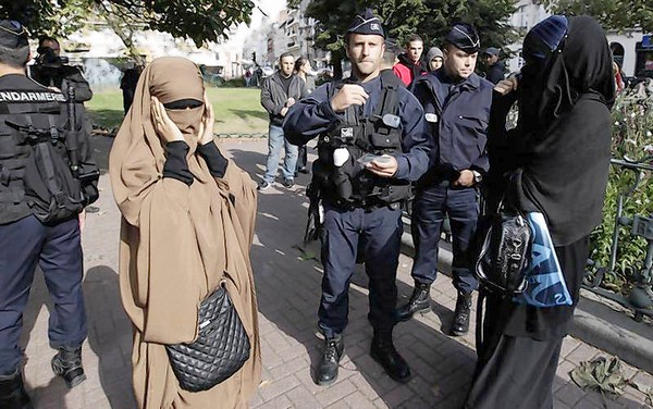 French police and gendarmes check identity cards of women wearing full-face veils, or niqab, as they arrived to demonstrate after calls on the internet by Islamic groups to protest over an anti-Islam video, in Lille