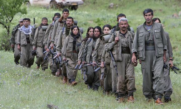 Kurdistan Workers Party (PKK) fighters walk on the way to their new base in northern Iraq