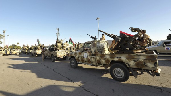 Demonstrators protest against armed militias as they welcome the arrival of the Libyan army in Benghazi