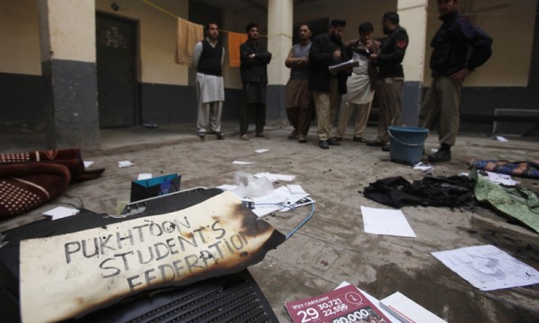 Policemen collect evidence and speak to witnesses at hostel after it was burnt during clash between two student groups on Valentine's Day at University of Peshawar