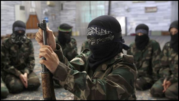 A female member of the Ahbab Al-Mustafa Battalion assembles a rifle during military training in a mosque in the Seif El Dawla neighbourhood in Aleppo