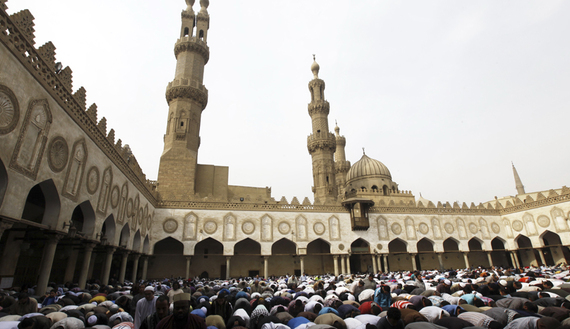 People perform Friday prayers led by Chairman of the International Union of Muslim Scholars Egyptian Cleric Sheikh Yusuf al-Qaradawi at Al Azhar mosque in old Cairo