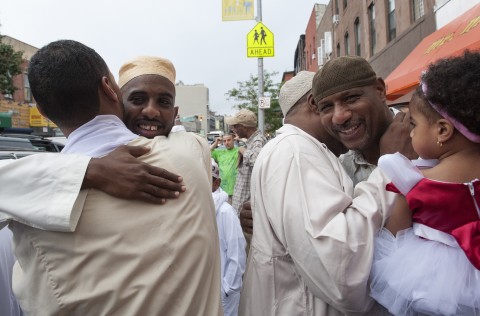 Sunni Muslims embrace each other after taking part in Eid al-Fitr prayers at a mosque in the Brooklyn borough of New York on August 8, 2013. Muslims in New York started to celebrate Eid al-Fitr on Thursday, an annual celebration which marks the end of the Islamic month of Ramadan.   REUTERS/Stephanie Keith (UNITED STATES - Tags: RELIGION) - RTX12E78