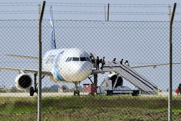 Passengers evacuate a hijacked EgyptAir Airbus 320 plane at Larnaca airport, Cyprus, March 29, 2016. REUTERS/Stringer