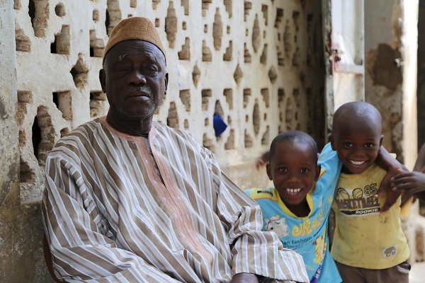 Boucar Gassama, father of medical student Sadio Gassama who left Senegal to join the Islamic State in Libya, sits in his courtyard surrounded by family in Ziguinchor, Senegal, in this picture taken March 3, 2016. REUTERS/Jean-Francois Huertas