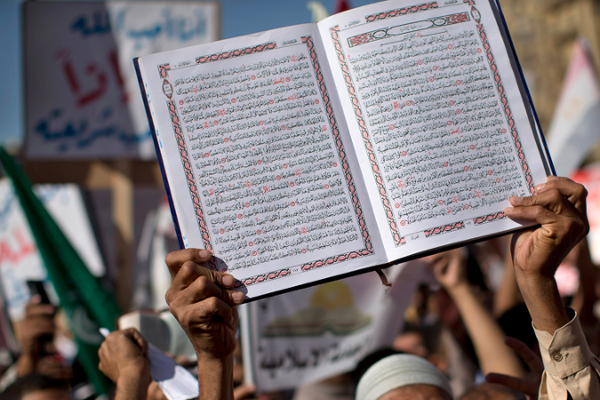 An Egyptian Muslim man holds the Quran, Islam's holy book, during a rally in Tahrir Square in Cairo, Friday, Nov. 9, 2012. Thousands of ultraconservative Muslims rallied in the Egyptian capital, demanding the country's new constitution be based on the rulings of Islamic law, or Shariah. (AP Photo/Bernat Armangue)