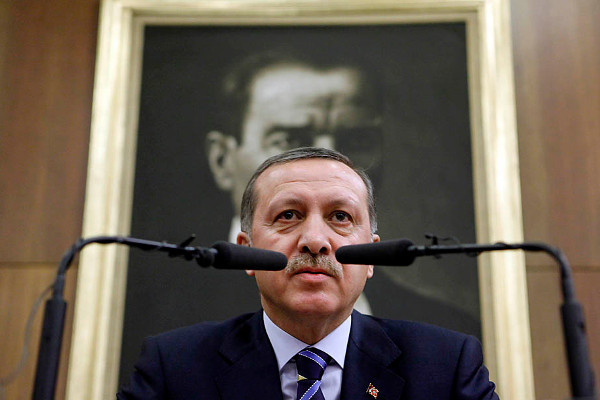 Turkey's Prime Minister Tayyip Erdogan addresses the media as he sits in front of a portrait of Mustafa Kemal Ataturk, founder of secular Turkey, in Ankara January 12, 2010. Muslim but secular Turkey is an important ally of the Jewish state of Israel but relations have cooled over strong criticism by Erdogan, whose AK party has roots in political Islam, of Israel's Gaza policies since last year. In the latest exchange, Israel issued a strong condemnation of Erdogan on Monday, saying his often fierce public criticism of its policies could undermine relations. REUTERS/Umit Bektas (TURKEY - Tags: POLITICS)
