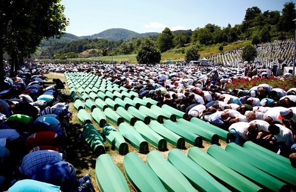 Muslim men pray in front of coffins during mass funeral in Potocari near Srebrenica, Bosnia and Herzegovina July 11, 2016. REUTERS/Dado Ruvic