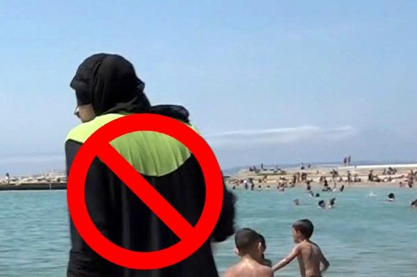 FILE - In this Aug.4 2016 file photo made from video, Nissrine Samali, 20, gets into the sea wearing traditional Islamic dress, in Marseille, southern France. The French resort of Cannes has banned full-body, head-covering swimsuits worn by some Muslim women from its beaches, citing security concerns. A City Hall official said the ordinance, in effect for August, could apply to burkini-style swimsuits.  (AP Photo, File)