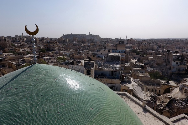A view taken with a drone shows the minaret of Osama Bin Zayed mosque along with damaged buildings in the old city of Aleppo, Syria. REUTERS/Abdalrhman Ismail