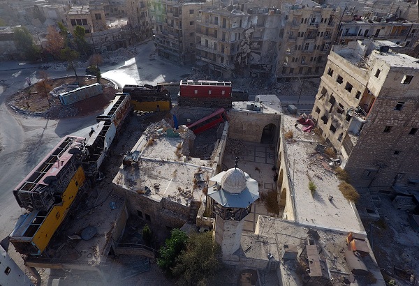 A view taken with a drone shows damaged buses positioned as barricades in the rebel-held Bab al-Hadid neighborhood of Aleppo, Syria. REUTERS/Abdalrhman Ismail